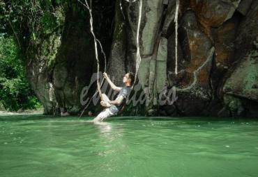 Salah satu pengunjung pemandian Lubuk Asan tampak bersantai sambil bergelantung akar pohon.
