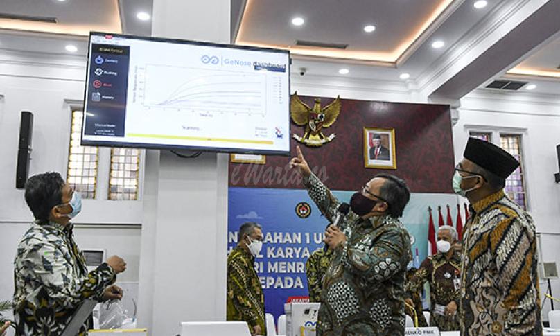 Menko PMK Muhadjir Effendy (kanan) menyimak penjelasan dari Menristek Bambang Brodjonegoro (kanan) tentang cara kerja alat deteksi dini COVID-19 bernama GeNose C19 pada layar televisi di Kantor Kemenko PMK, Jakarta, Kamis (7/1/2021) - (antarafoto)