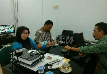 Polisi dan karyawan Bank serta Septi Meriani mengecek uang pecahan 50.000 yang di duga palsu